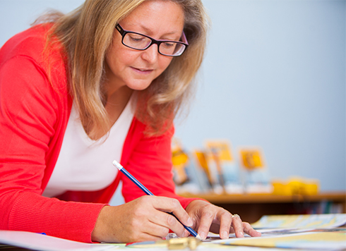 Woman in a classroom doing chartwork