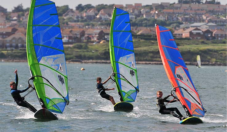 RYA windsurfing courses for kids and adults. Try a new watersport 2022. Credit Andy Stallman.