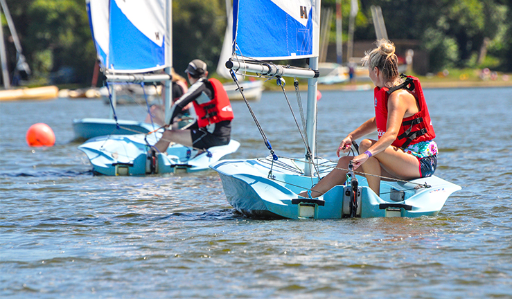 Wavelength July 2021 - staycations. Man and woman sailing dinghies.