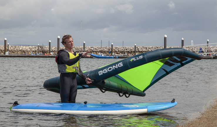 Male instructing how to use the wing in the water