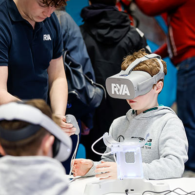 a very young boy wearing VR headset