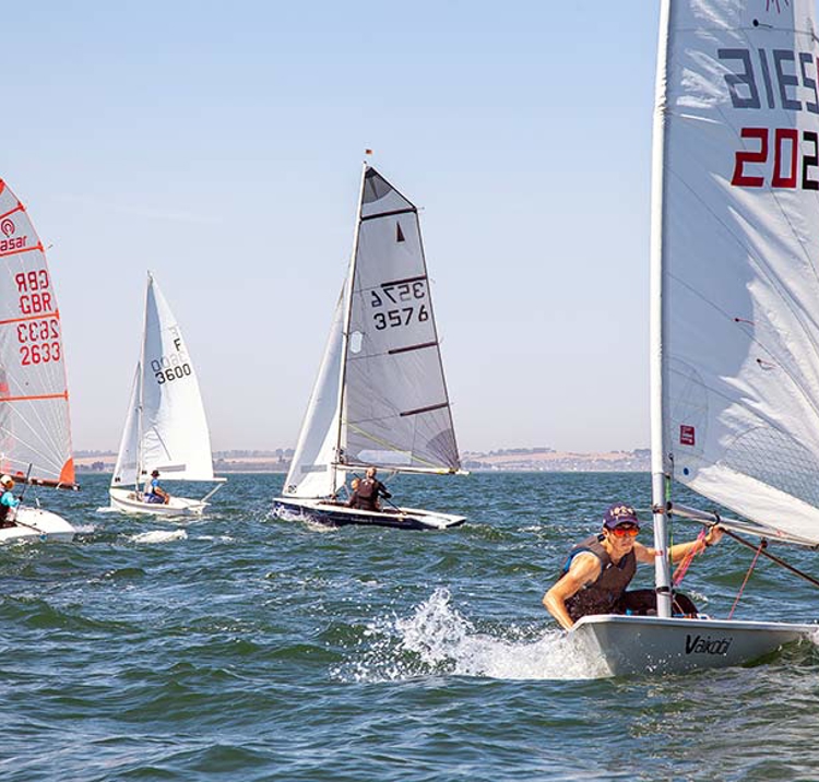numerous dinghies in the ocean racing