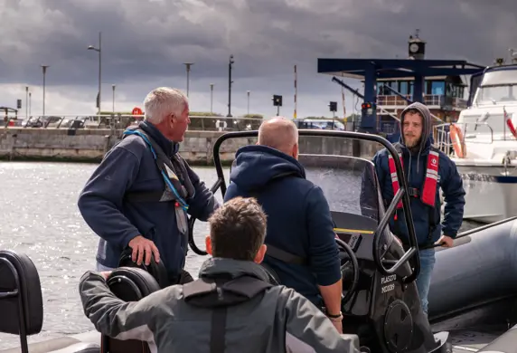 Adult students on a Humber rigid inflatable boat (RIB) receiving instruction from a trainer from Guardian Marine Training Services, Chatham