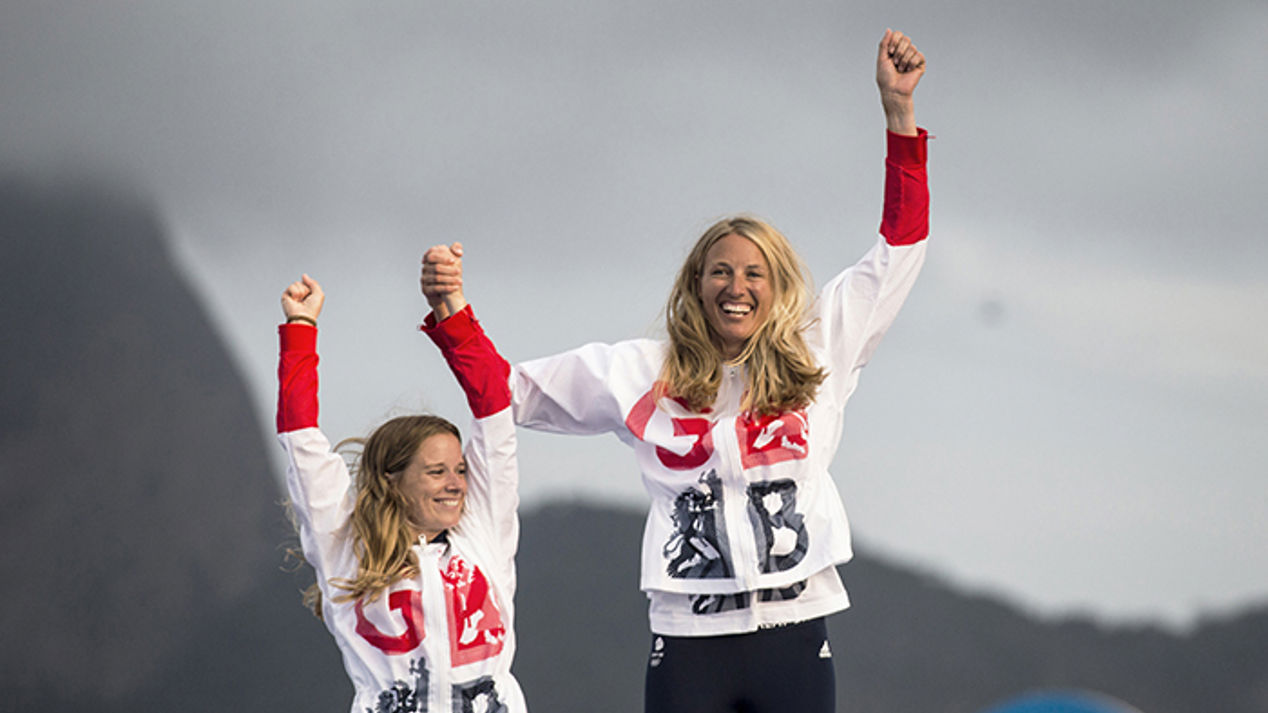 Two young sailors jumping in the air and celebrating 