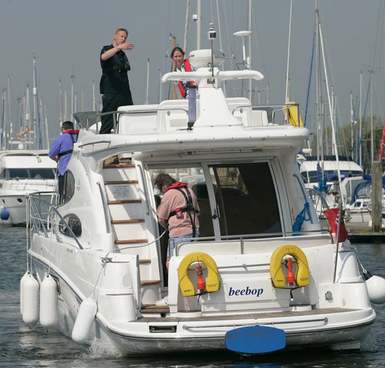 Behind view of a motor cruiser heading in to a marina