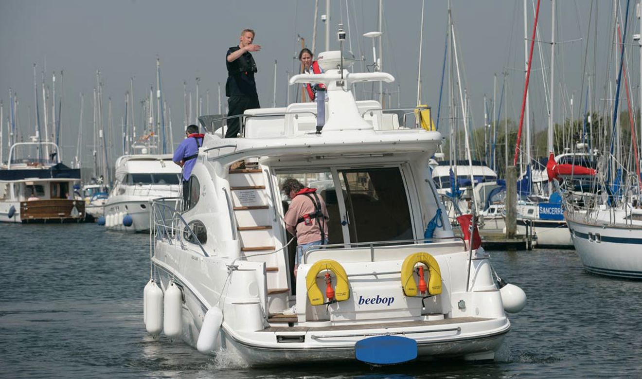 Behind view of a motor cruiser heading in to a marina