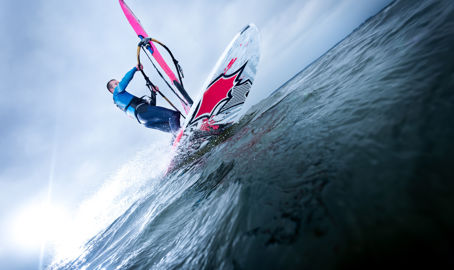 Shot of man windsurfing from the water looking up