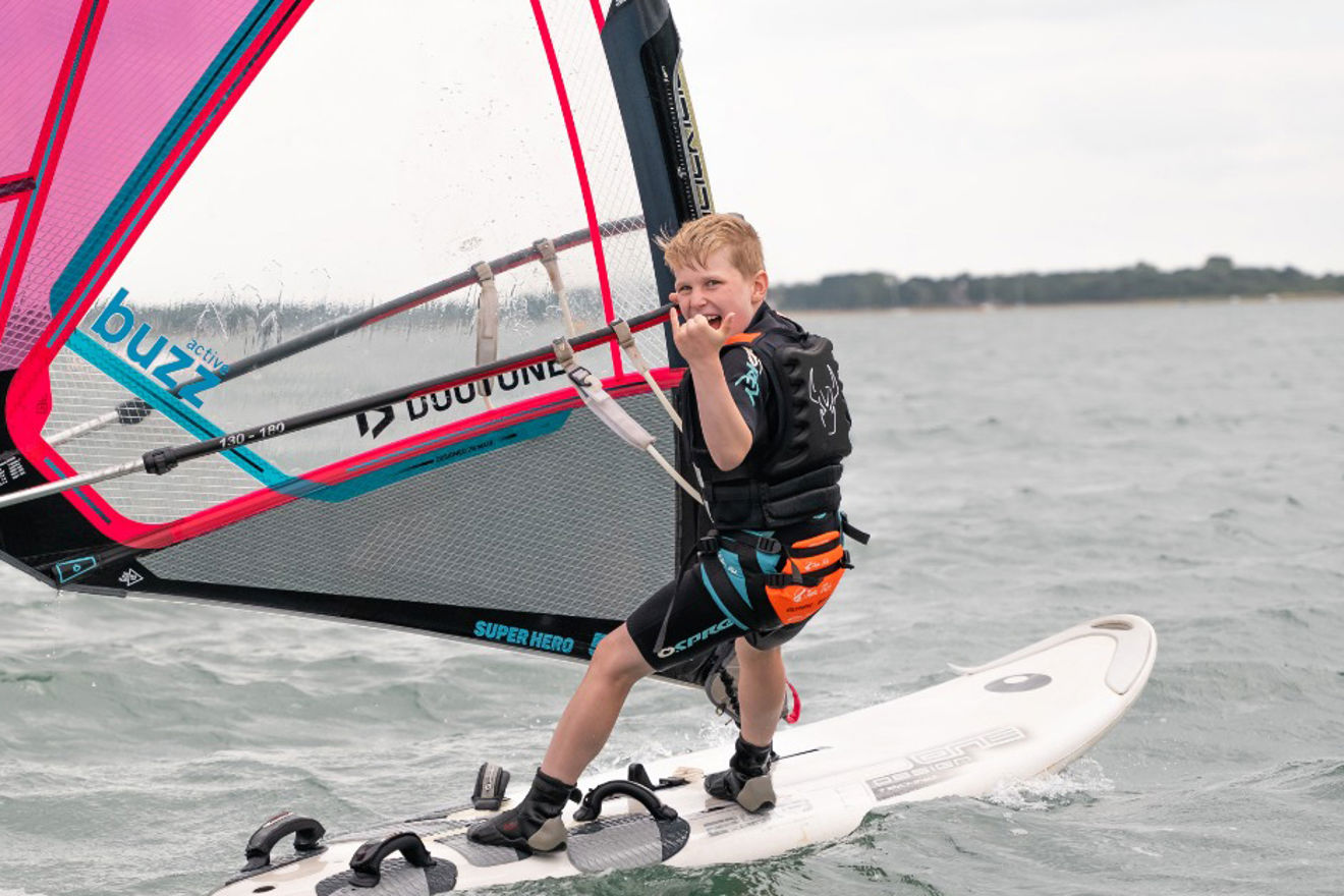 Child smiling on a dinghy