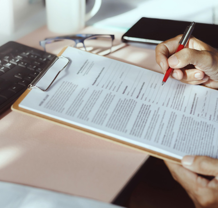 signing of a document on a clipboard