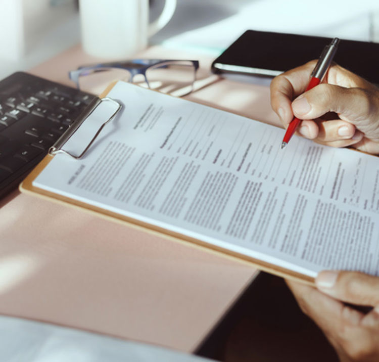 signing of a document on a clipboard