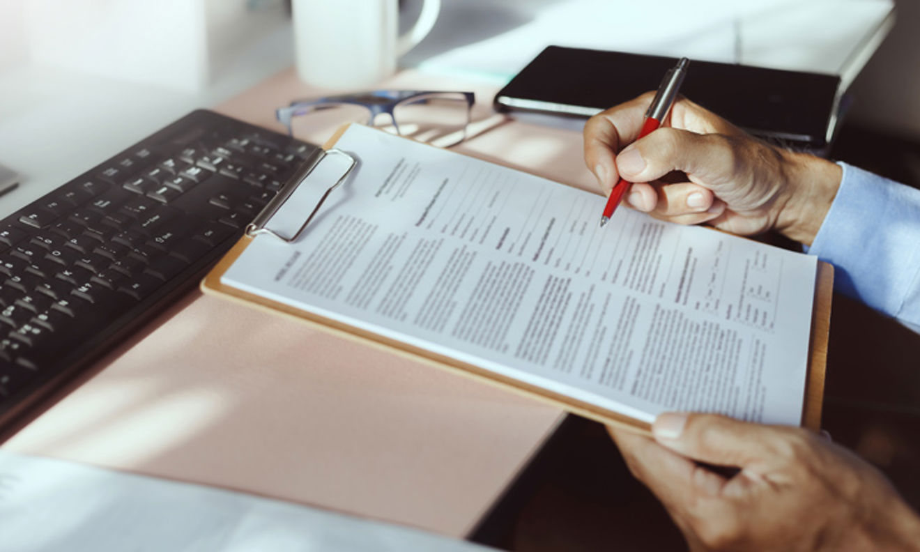signing of a document on a clipboard