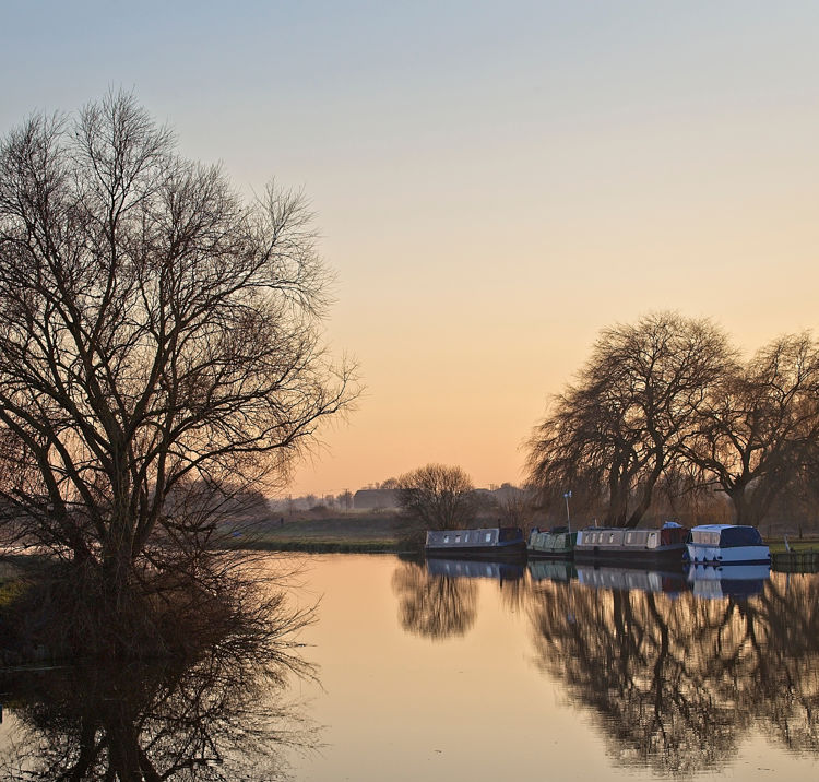 narrowboats moored on waterways in winter