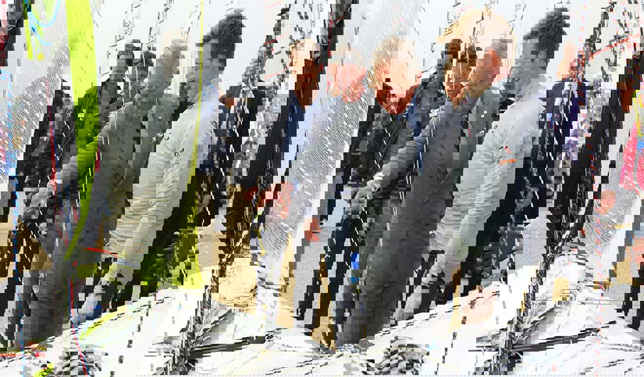 Prince Charles being shown a young man's boat