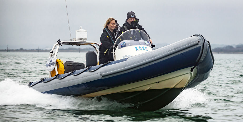 Powerboat instructor instructing a pupil on the water