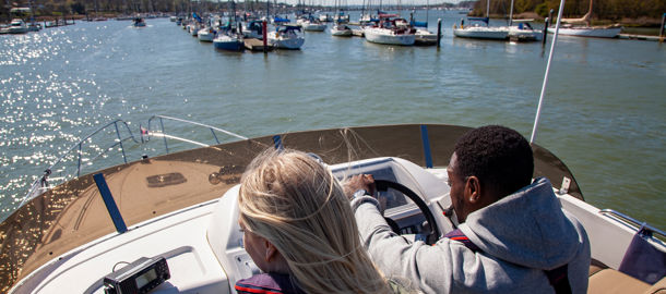 birdseye view of couple steering a powerboat