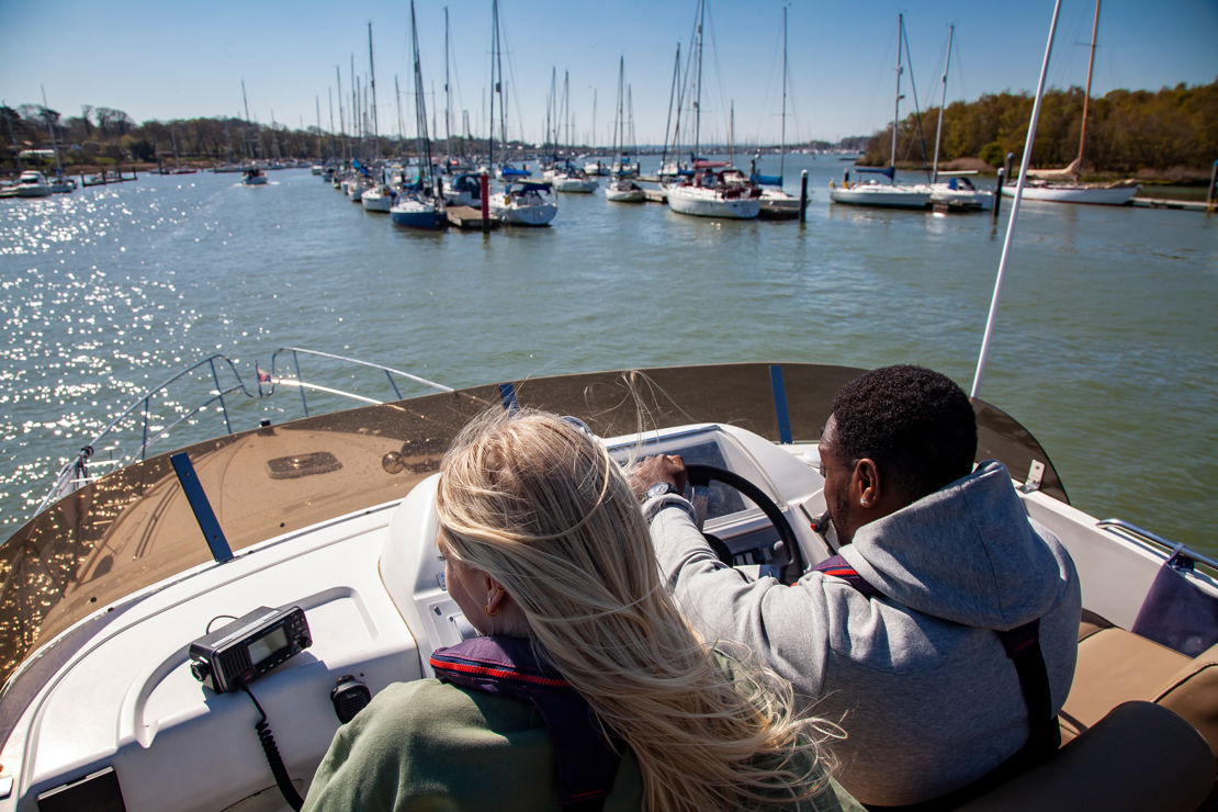 birdseye view of couple steering a powerboat