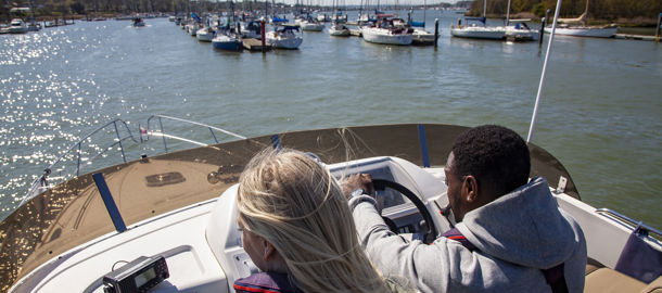 birdseye view of couple steering a powerboat