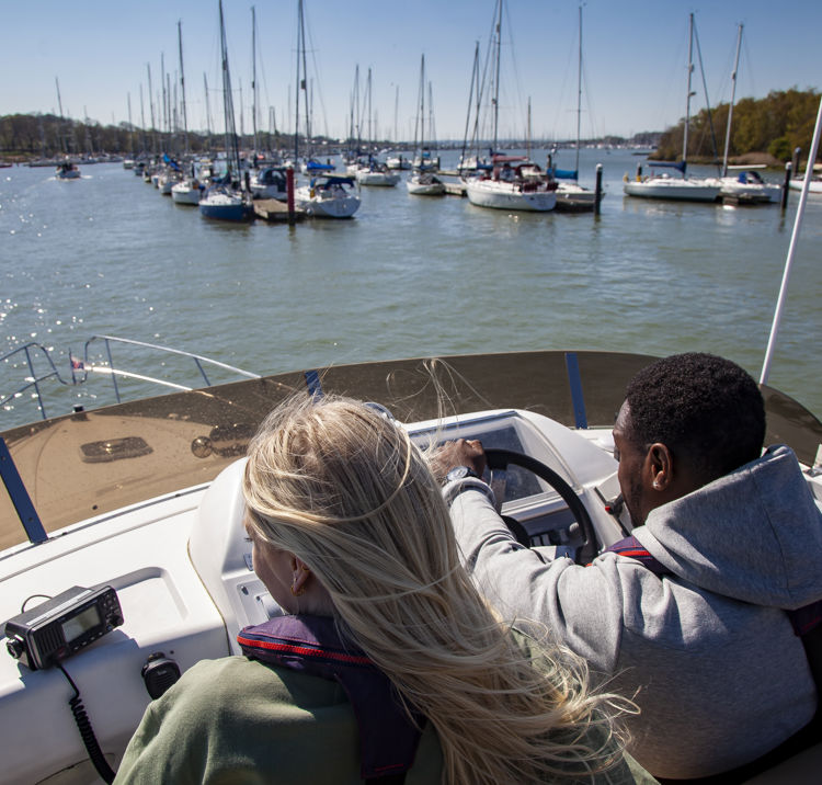 birdseye view of couple steering a powerboat