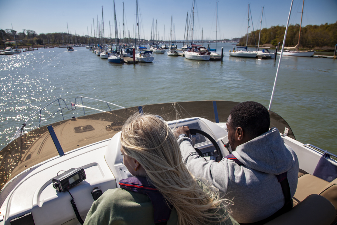 birdseye view of couple steering a powerboat