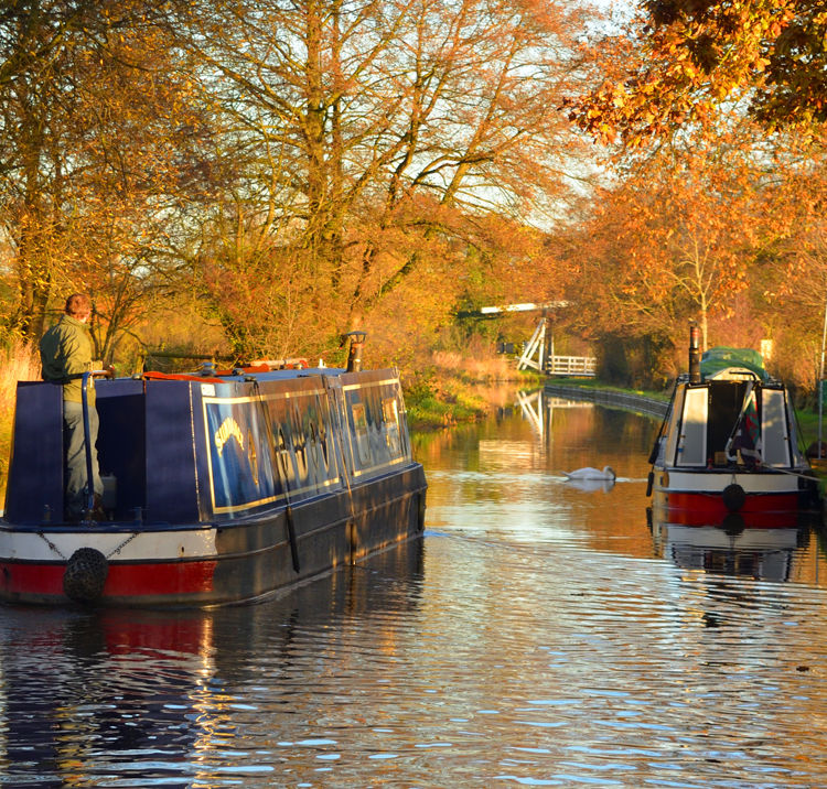 canal boat navigating the waterways in autumn 