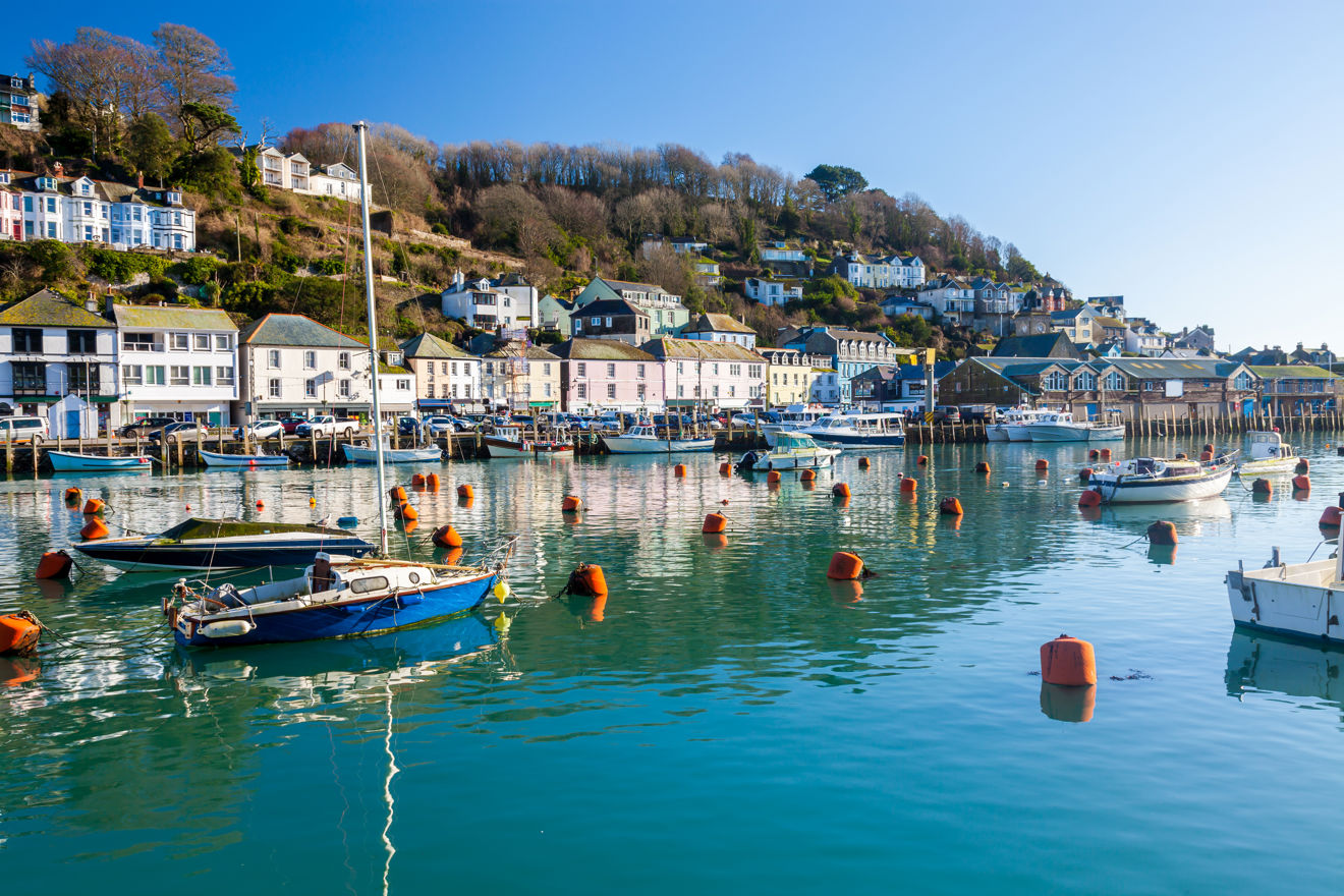 Wide shot of blue water and boats at the Cornish Harbour