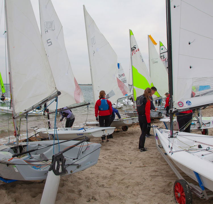 Dinghies on the shore before a session on the water