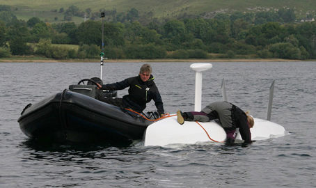 boat assisting in keelboat recovery during capsize