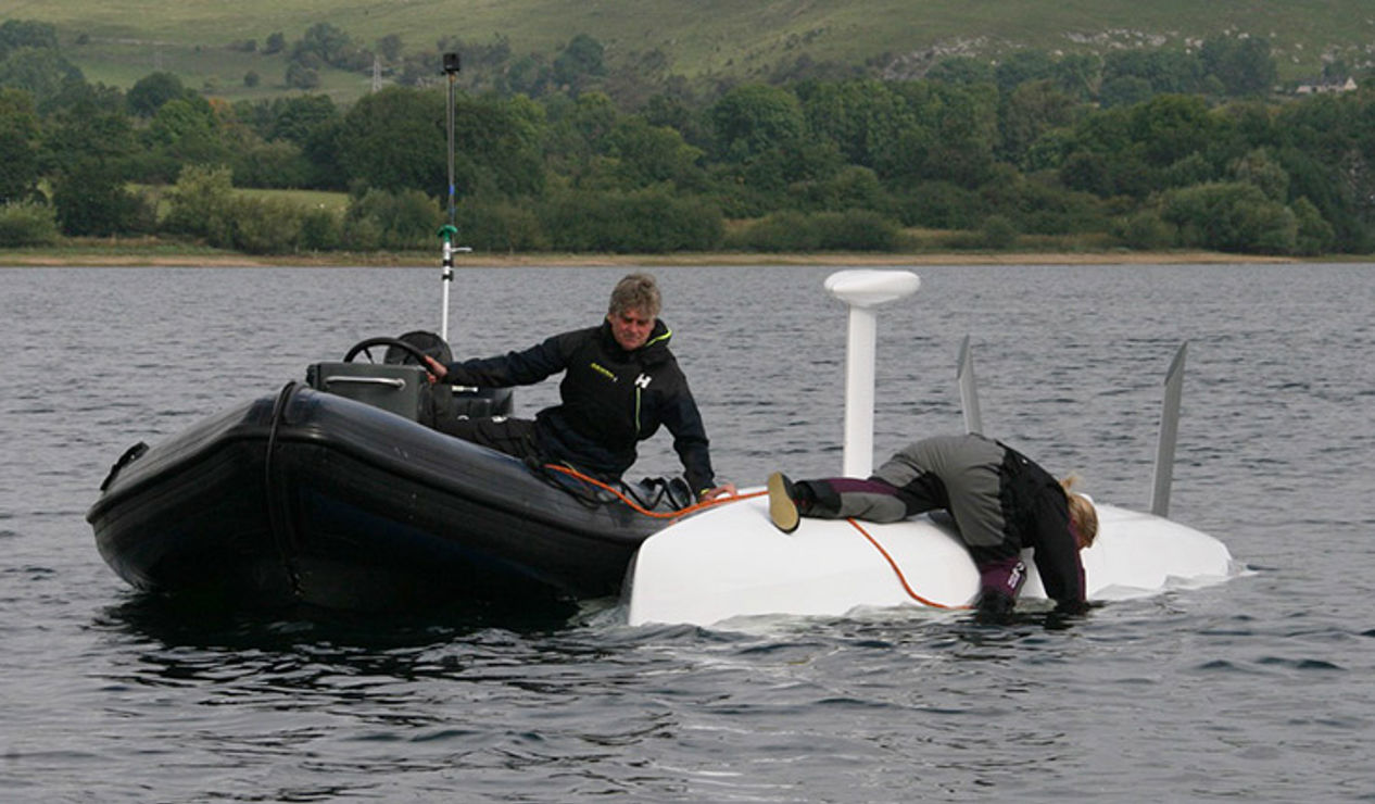 boat assisting in keelboat recovery during capsize