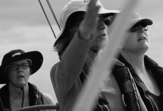 A competent crew of ladies on a yacht in black and white
