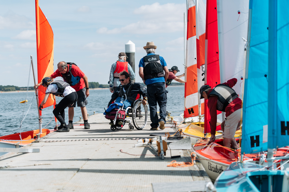 numerous people on the dock checking the dinghies