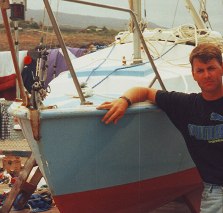 Dave Clarke leaning against his boat