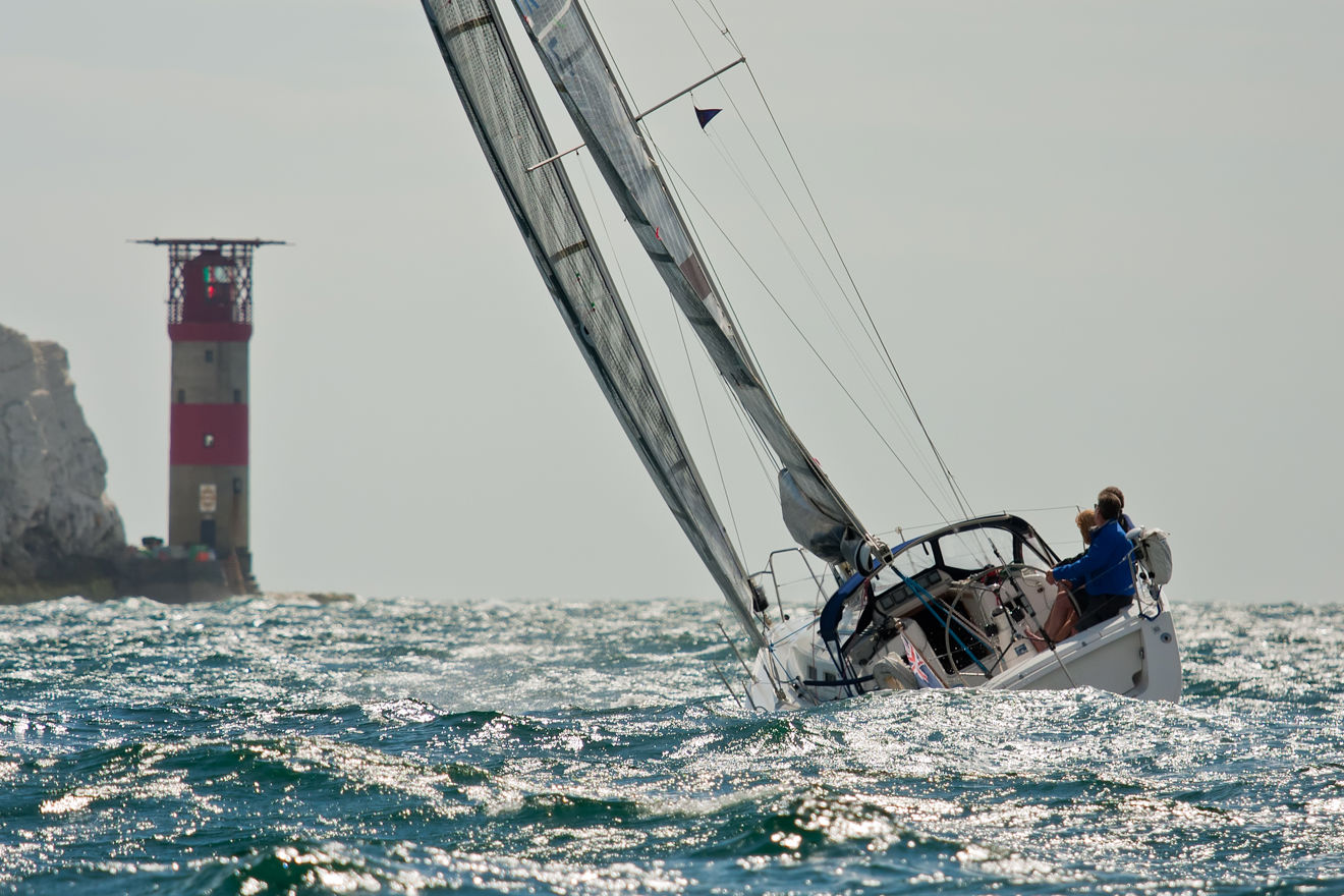 A yacht sailing through crashing waves