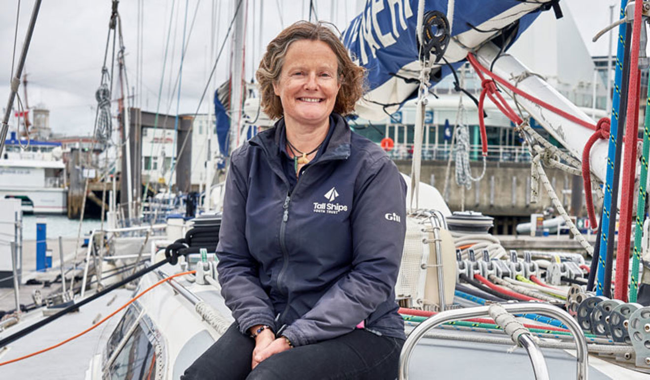 Sue Geary sitting on a yacht looking at the camera smiling