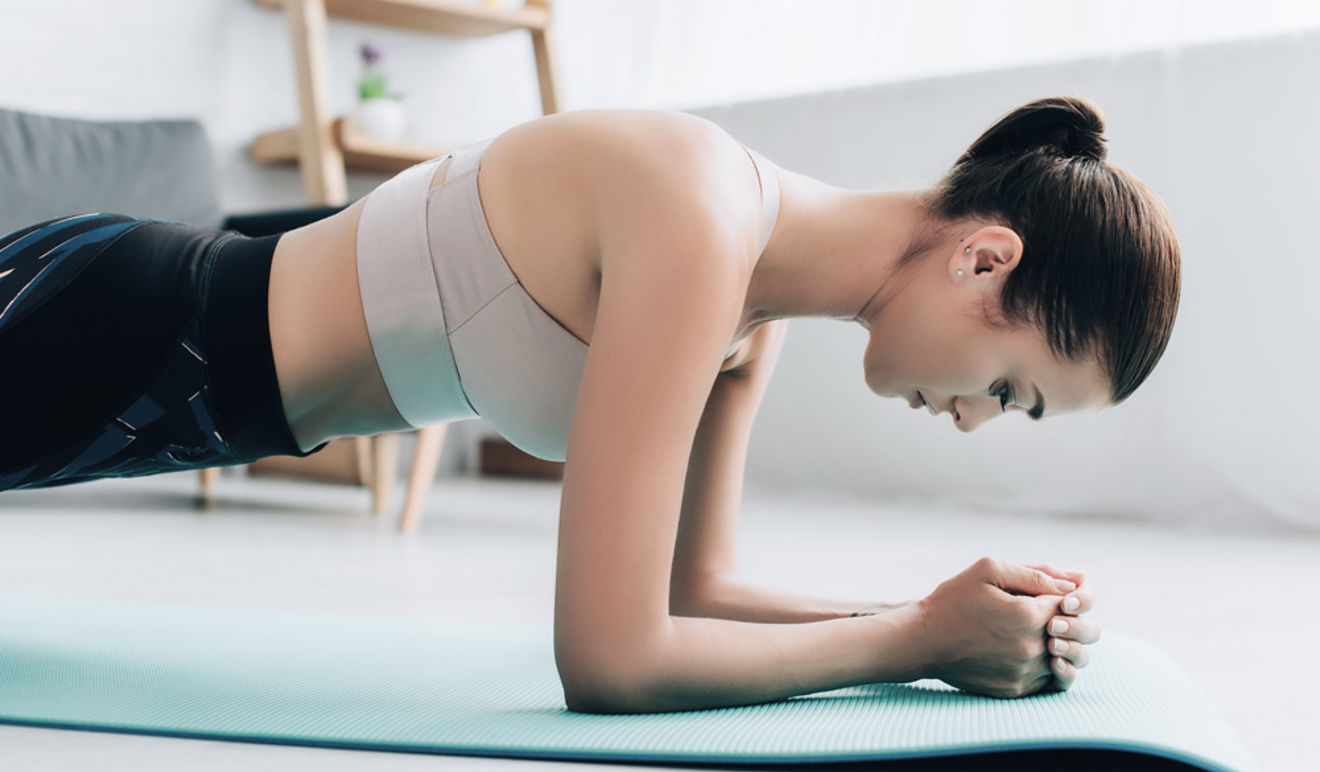 	An image of a women working out on a yoga mat mode of exercise is Planking