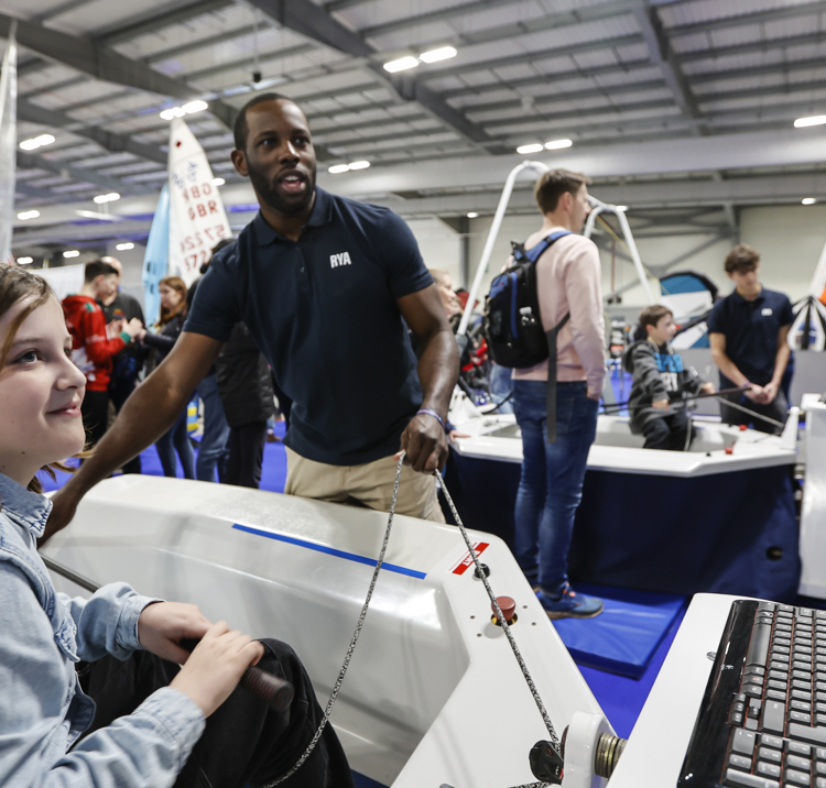 Mid shot of child taking part in an interactive sailing simulator at the Dinghy Show