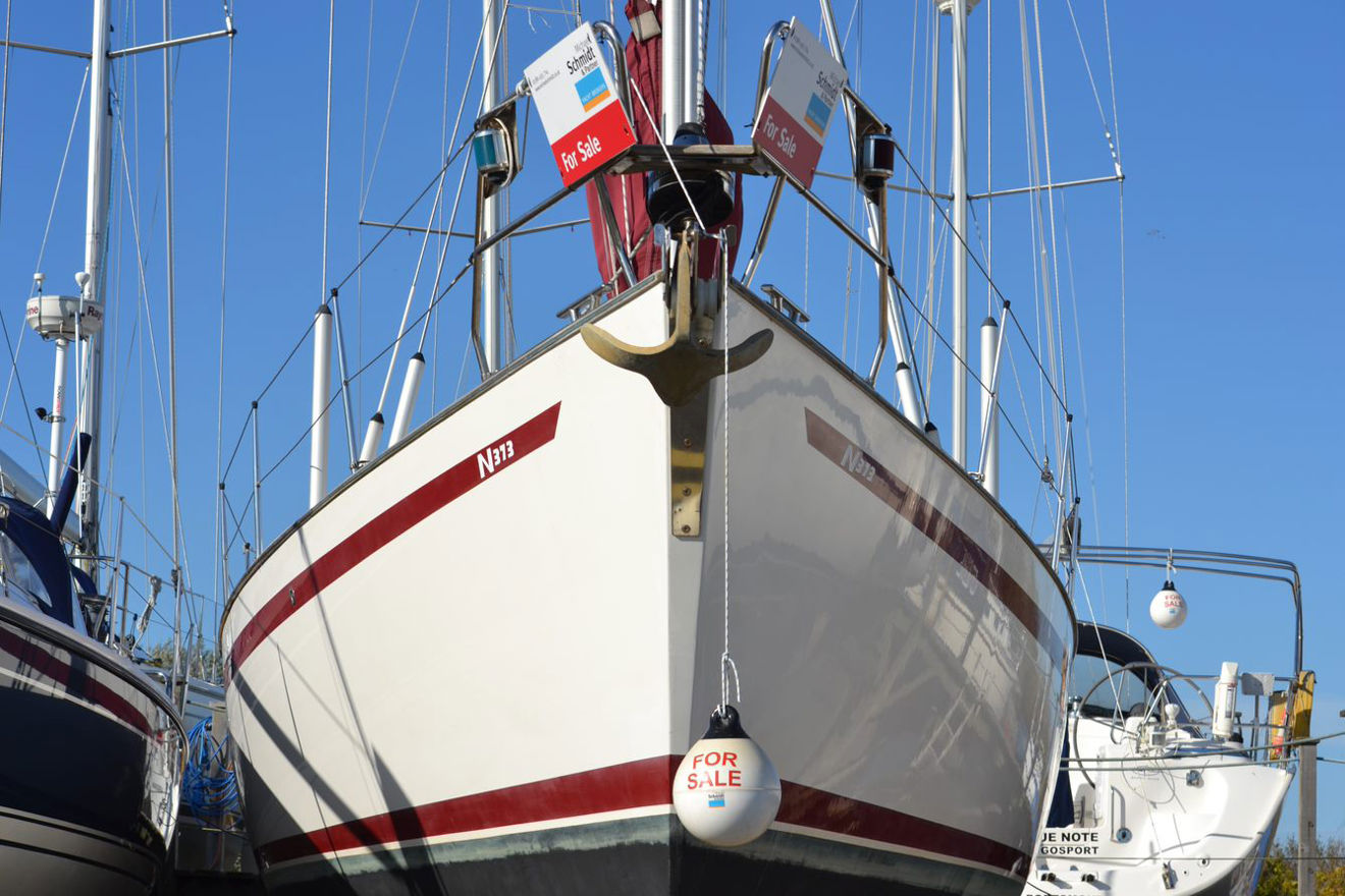 a large yatch with a for sale sign on the stern