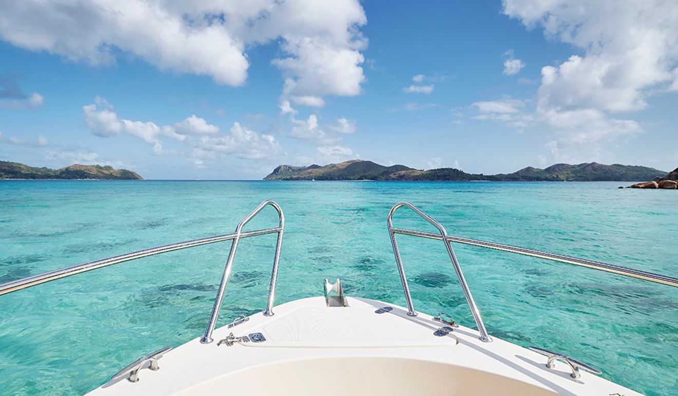 close up of bow of ship at sea with turquoise water 