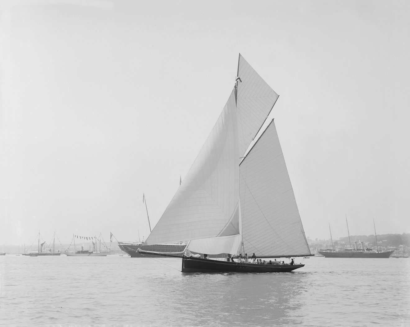 Black and white image of traditional sail boat with large sails