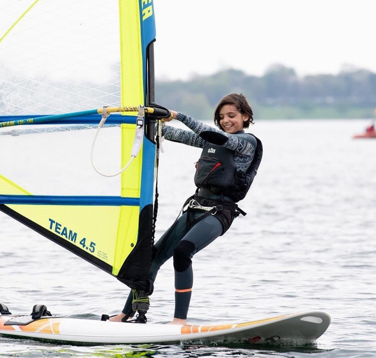 Wide shot of Ruby Webb windsurfing 