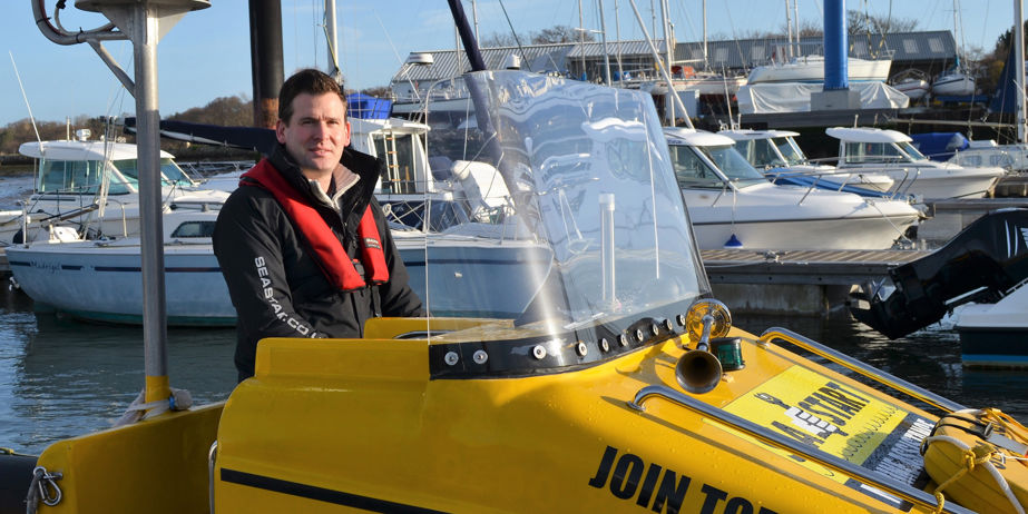 Jonothan Parker at the helm of a boat