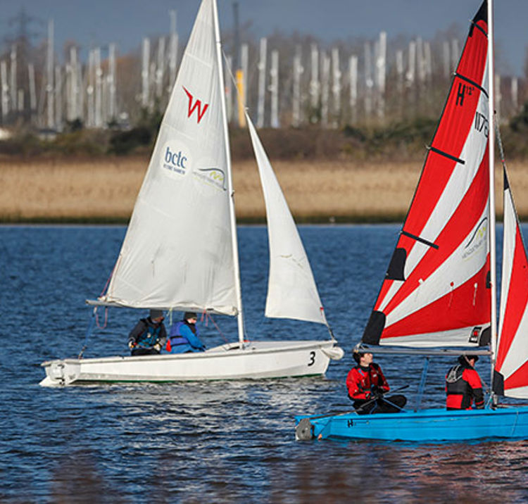 Two dinghies sailing side by side