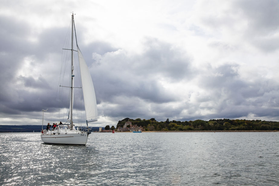 wide shot of yacht sailing across lake