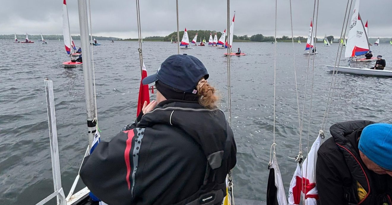 Welsh Sailing volunteer Emily Cook on a committee boat as a course race officer at the Eric Twiname Junior Championships 2026.