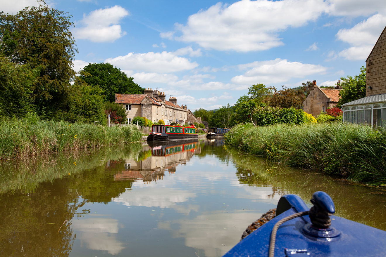 POV shot from canal boat looking onto another canal boat in distance