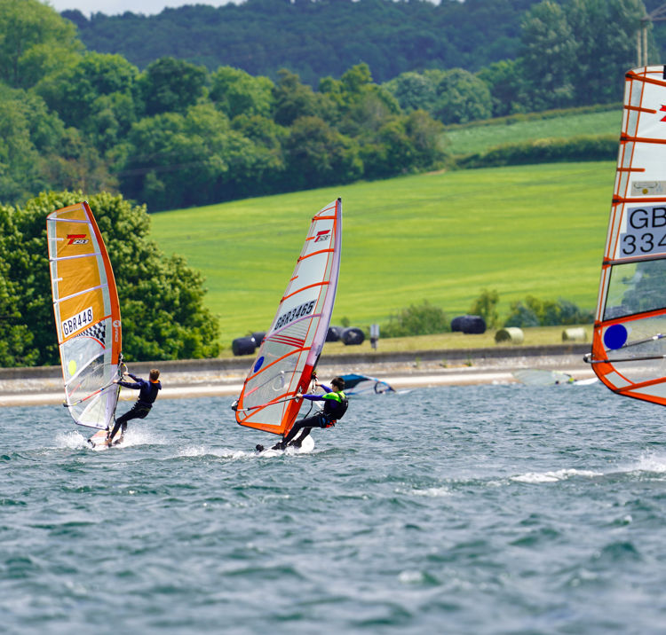 Dinghies sailing with idyllic hills in the background