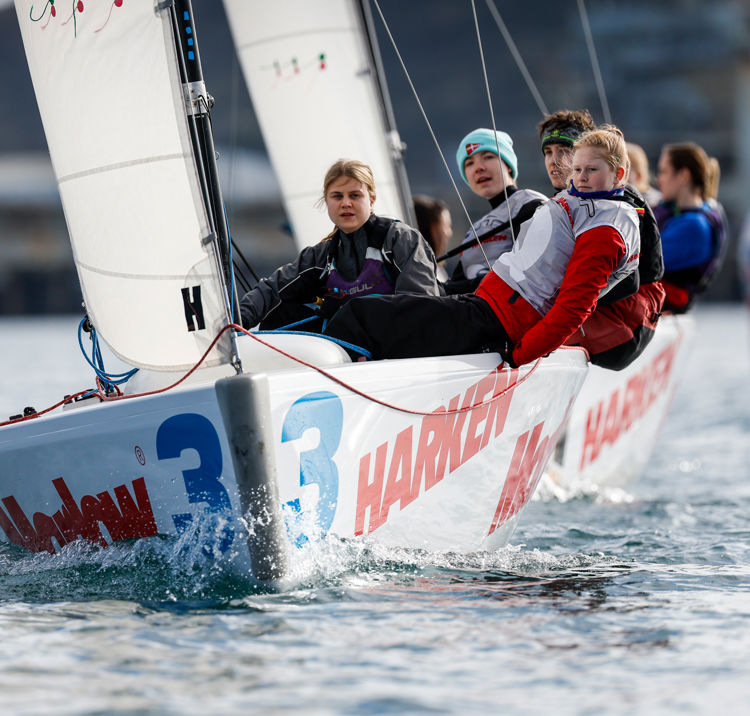 young people sailing on a dinghy 