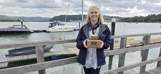 All Afloat charity trustee Petrina Blomeley by the water in North Wales with her RYA CW Impact Award.