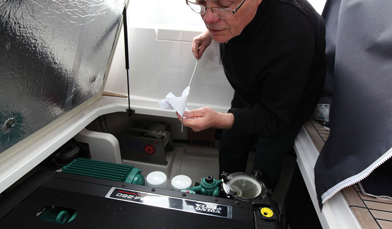 A man carrying out boat engine checks