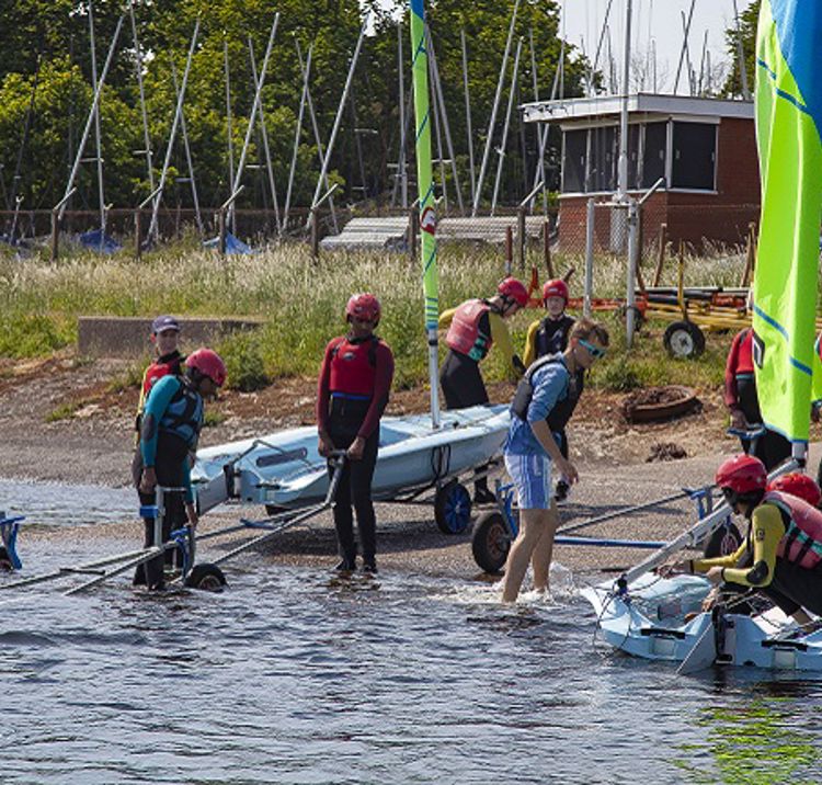 Children bringing dinghy down Bartley Slipway