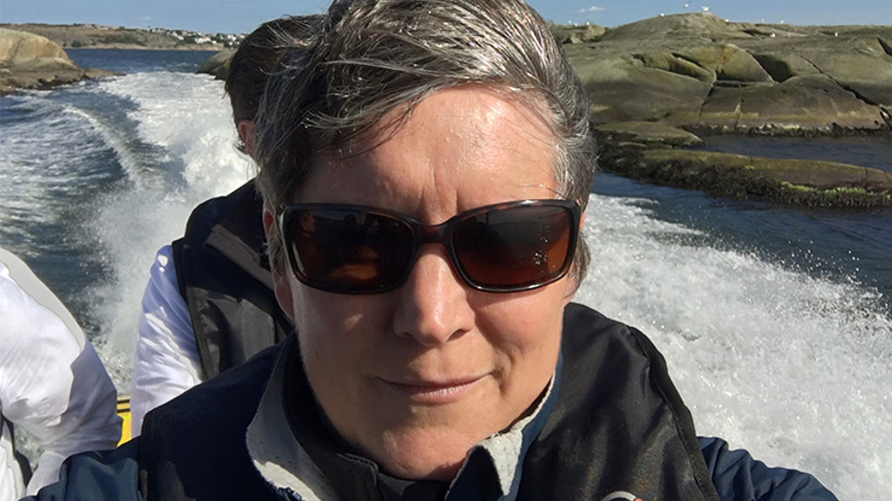 Mid shot of Rachel Andrews stood on bow of her boat